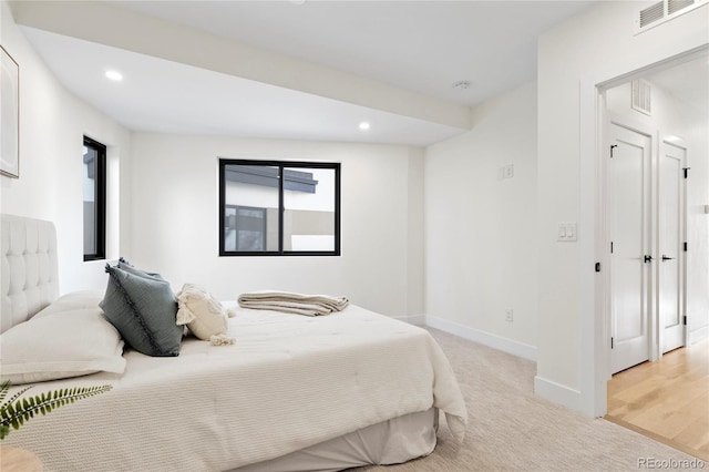 bedroom with light colored carpet, recessed lighting, visible vents, and baseboards