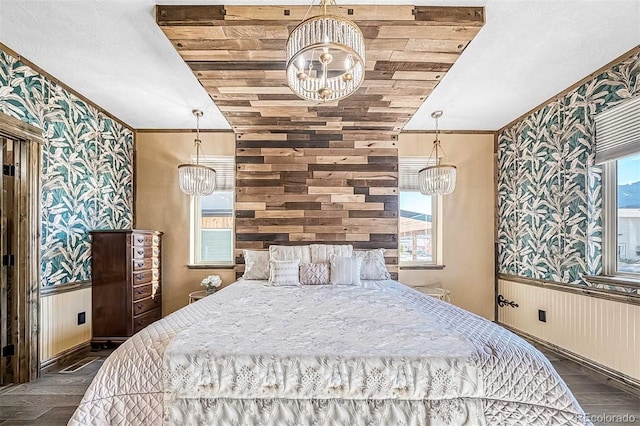 bedroom featuring multiple windows, dark wood-type flooring, and vaulted ceiling