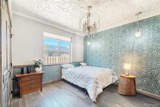 bedroom featuring hardwood / wood-style floors and a notable chandelier