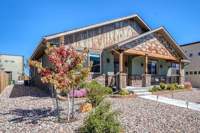 craftsman-style home featuring covered porch and central AC unit