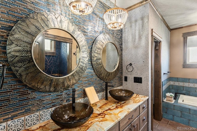 full bath with double vanity, tile patterned flooring, ornamental molding, and a sink