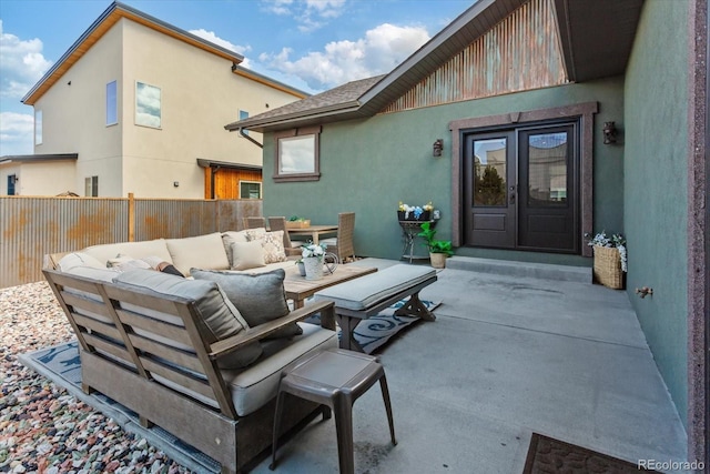 view of patio / terrace with fence, an outdoor living space, and french doors
