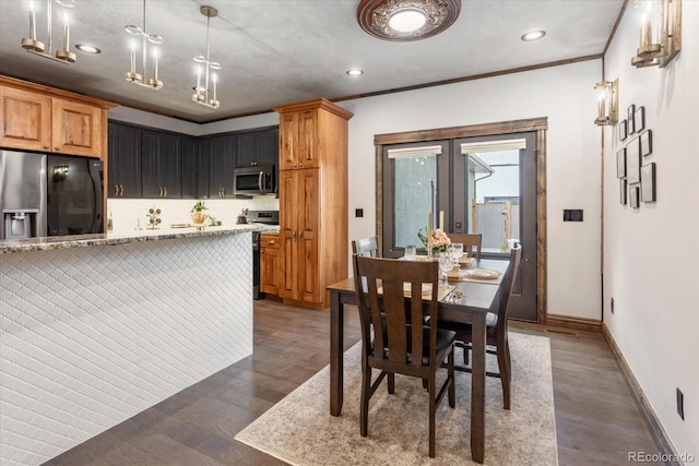 dining space featuring baseboards, recessed lighting, and wood finished floors