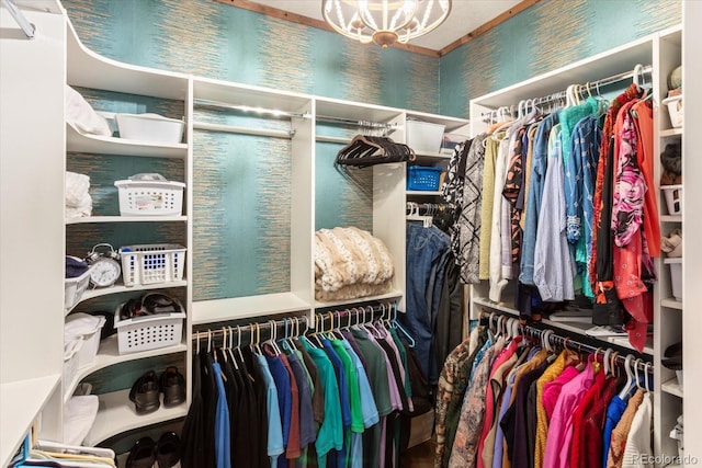 walk in closet featuring an inviting chandelier