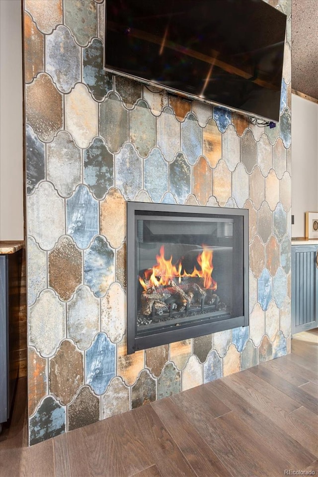 interior details with wood finished floors and a fireplace