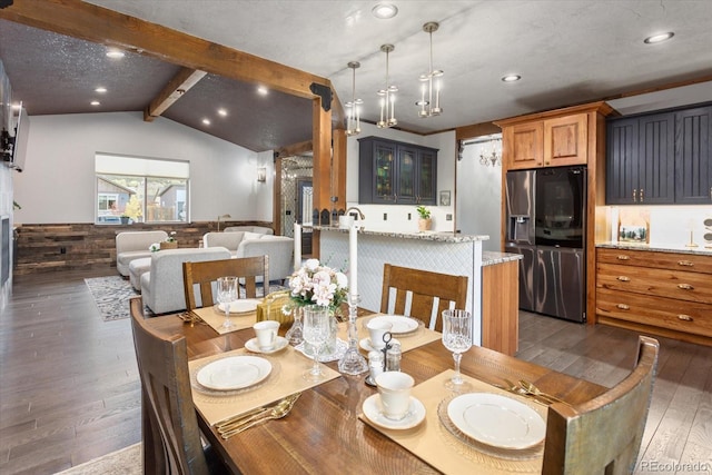 dining space with recessed lighting, lofted ceiling with beams, wainscoting, and dark wood finished floors