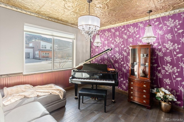 living area featuring wood-type flooring, an ornate ceiling, and a notable chandelier