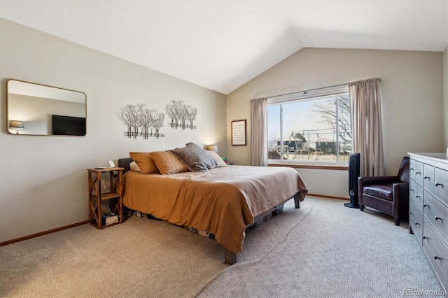 bedroom featuring light carpet, baseboards, and vaulted ceiling