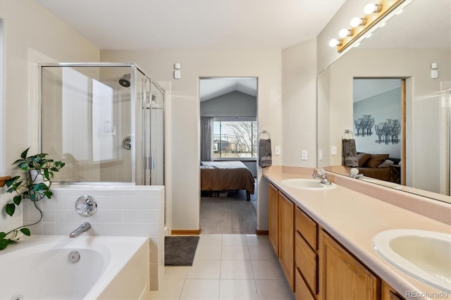 full bathroom featuring ensuite bath, double vanity, a sink, a shower stall, and a garden tub