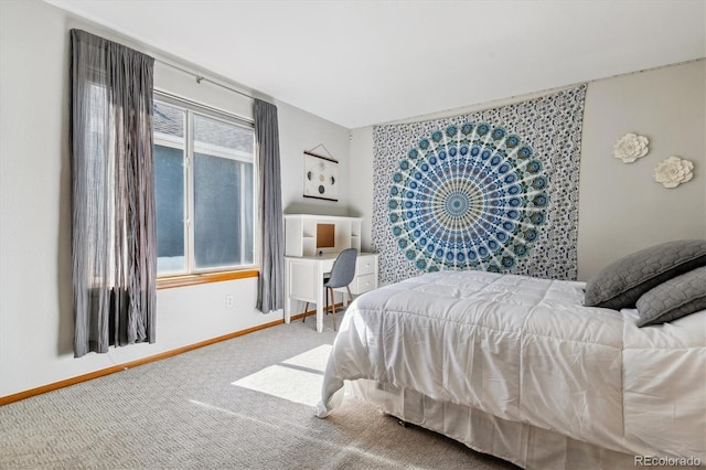 carpeted bedroom featuring baseboards