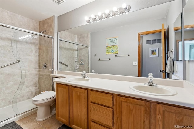 bathroom with tile patterned flooring, a stall shower, double vanity, and a sink