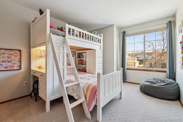 bedroom featuring light colored carpet and baseboards