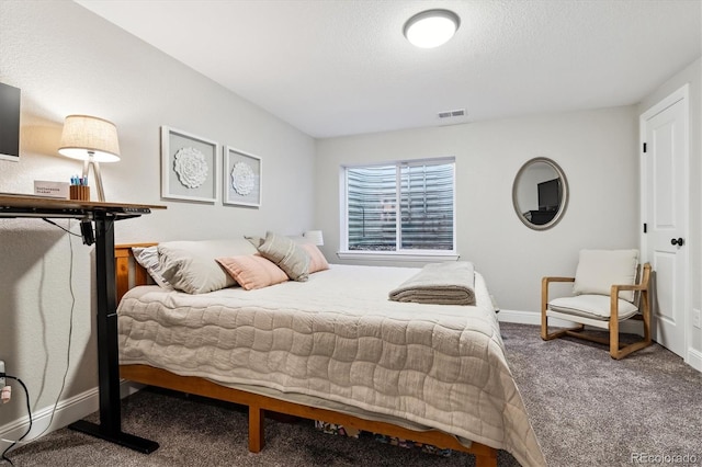 carpeted bedroom featuring visible vents, baseboards, and a textured ceiling