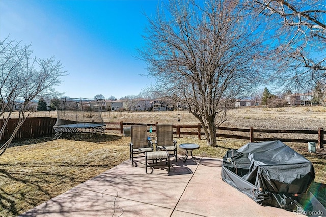 view of patio / terrace featuring a trampoline and fence