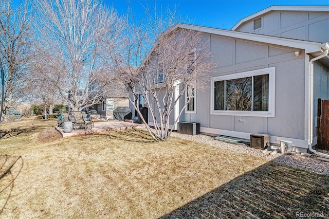 back of property with a patio area and a lawn