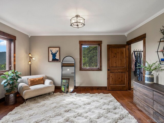 1194 Snyder Mountain Rd, Evergreen, CO 80439 - sitting room with crown molding, wood finished floors, and a chandelier