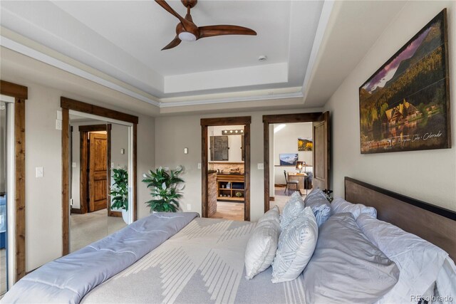 1194 Snyder Mountain Rd, Evergreen, CO 80439 - bedroom featuring a raised ceiling, light colored carpet, and a ceiling fan