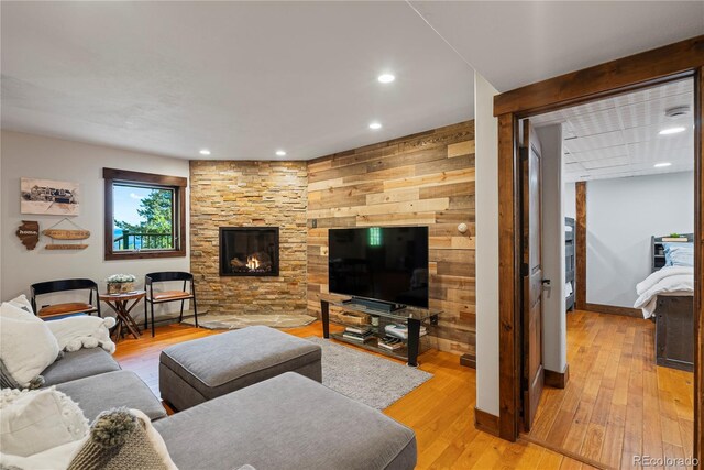 1194 Snyder Mountain Rd, Evergreen, CO 80439 - living room featuring light wood-style flooring, recessed lighting, and a stone fireplace