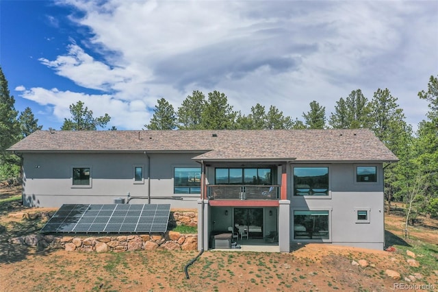 2754 County Rd 421, Florissant, CO 80816 - rear view of property with solar panels, a balcony, stucco siding, and a patio