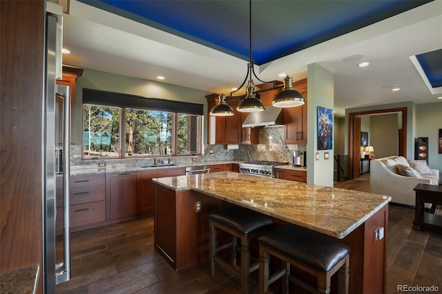 2754 County Rd 421, Florissant, CO 80816 - kitchen featuring a sink, range, wall chimney exhaust hood, light stone counters, and a kitchen island