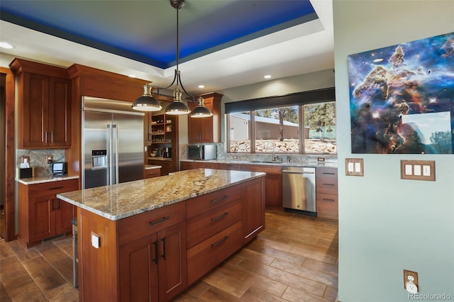 2754 County Rd 421, Florissant, CO 80816 - kitchen featuring appliances with stainless steel finishes, decorative backsplash, a sink, a raised ceiling, and light stone countertops