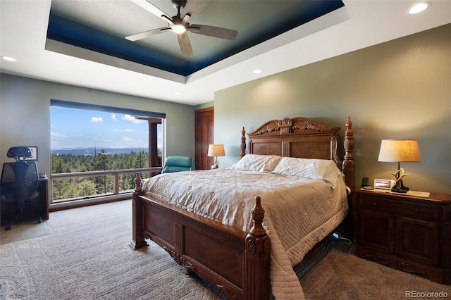 2754 County Rd 421, Florissant, CO 80816 - carpeted bedroom with a tray ceiling, recessed lighting, a desk, ceiling fan, and access to outside