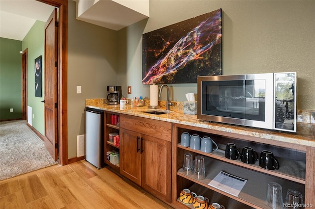 2754 County Rd 421, Florissant, CO 80816 - indoor wet bar with stainless steel microwave, fridge, and light wood-style floors