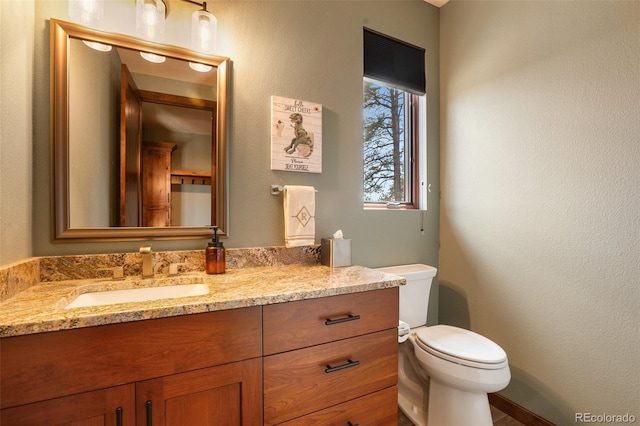 2754 County Rd 421, Florissant, CO 80816 - half bath featuring toilet, vanity, and a textured wall