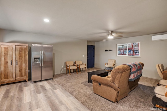 2754 County Rd 421, Florissant, CO 80816 - living area with a wall mounted AC, ceiling fan, light wood-type flooring, and baseboards