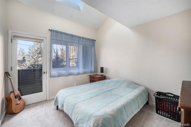 bedroom with lofted ceiling with skylight, access to outside, multiple windows, and light colored carpet