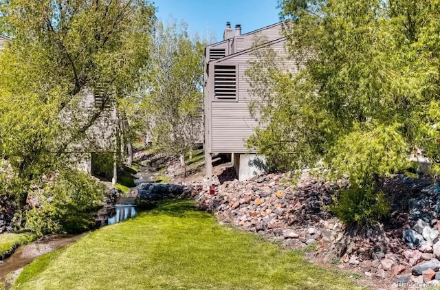 view of side of home featuring a yard