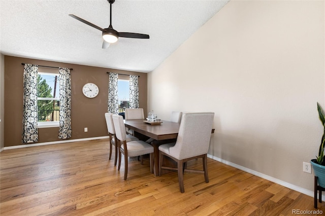 8804 Lariat Loop, Elizabeth, CO 80107 - dining space with ceiling fan, healthy amount of natural light, light wood finished floors, a textured ceiling, and vaulted ceiling