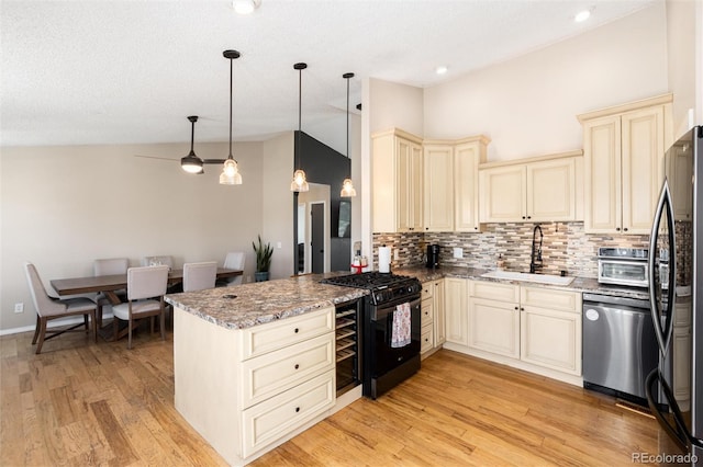 8804 Lariat Loop, Elizabeth, CO 80107 - kitchen featuring cream cabinets, black appliances, tasteful backsplash, vaulted ceiling, and light stone counters
