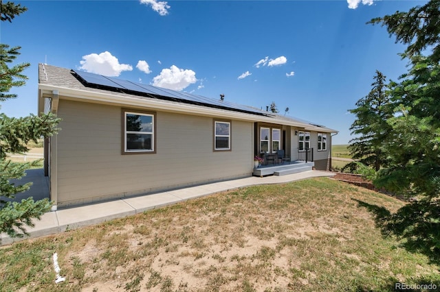 8804 Lariat Loop, Elizabeth, CO 80107 - rear view of house with roof mounted solar panels and a yard