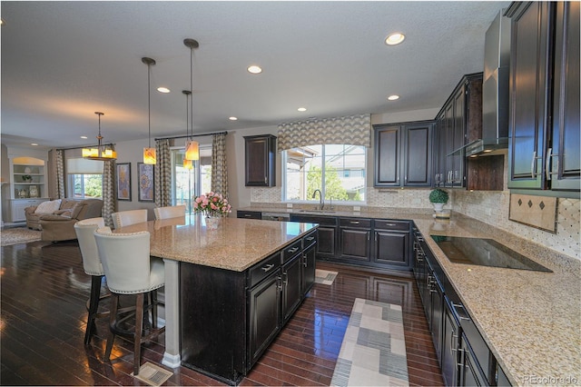 14193 Double Dutch Cir, Parker, CO 80134 - kitchen featuring a sink, black electric cooktop, plenty of natural light, a kitchen breakfast bar, and recessed lighting