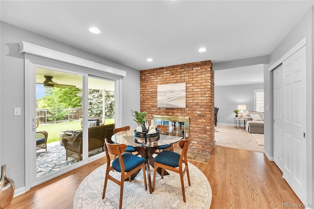 8896 W Prentice Ave, Littleton, CO 80123 - dining room featuring healthy amount of natural light, light wood-type flooring, recessed lighting, baseboards, and a brick fireplace