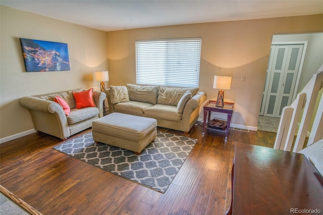 living room featuring dark wood-type flooring