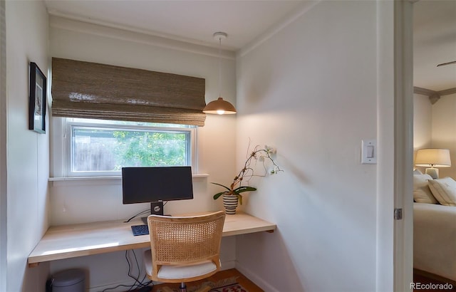 office space with baseboards and crown molding