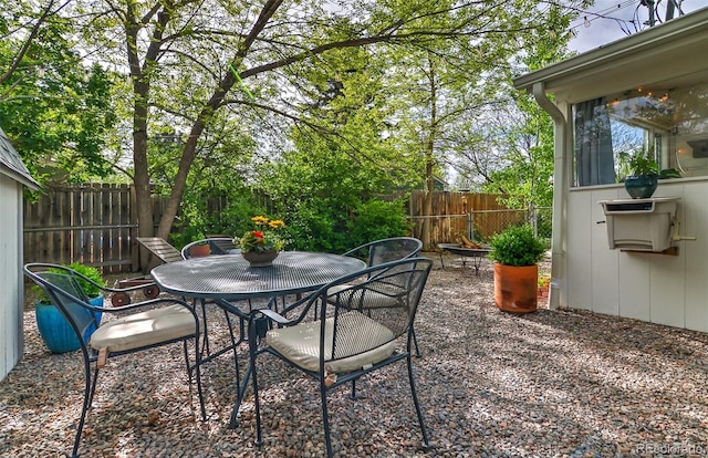 view of patio with a fenced backyard and outdoor dining space