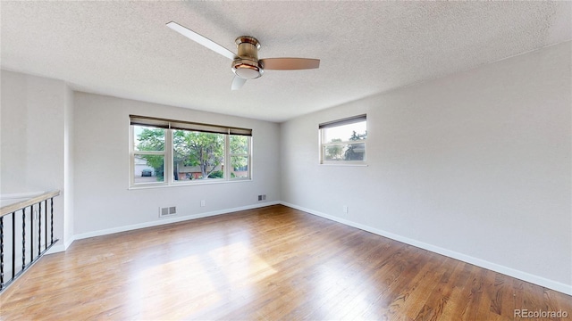 11718 Keough Dr, Northglenn, CO 80233 - spare room with a ceiling fan, wood finished floors, and a textured ceiling