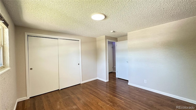 11718 Keough Dr, Northglenn, CO 80233 - unfurnished bedroom with wood finished floors, a closet, and a textured ceiling