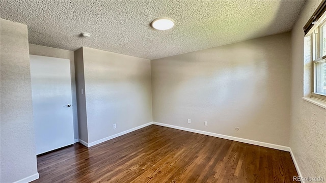 11718 Keough Dr, Northglenn, CO 80233 - spare room with dark wood-type flooring and a textured ceiling