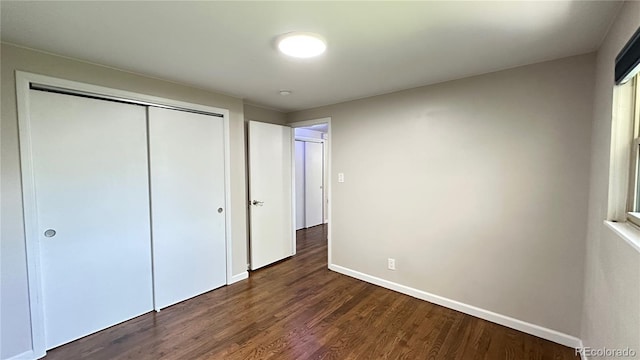 11718 Keough Dr, Northglenn, CO 80233 - unfurnished bedroom with dark wood-type flooring and a closet