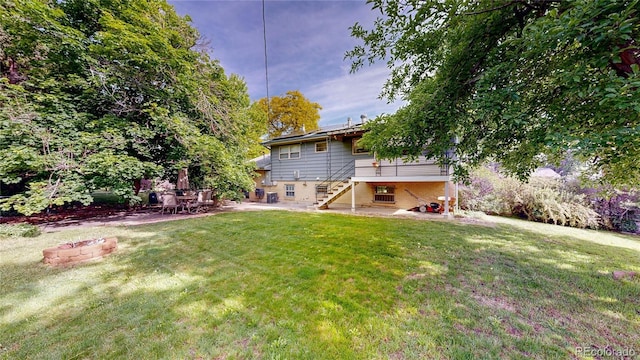 11718 Keough Dr, Northglenn, CO 80233 - view of grassy yard with stairs and a patio