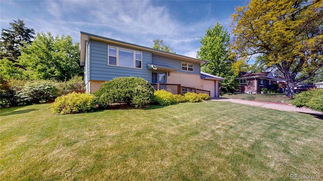 11718 Keough Dr, Northglenn, CO 80233 - raised ranch with brick siding, a front yard, and an attached garage