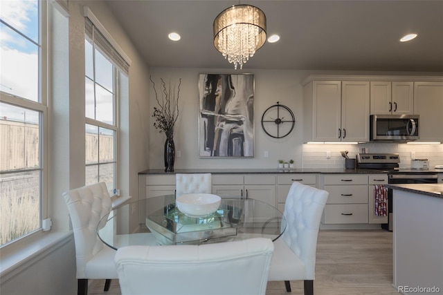 dining area with an inviting chandelier, recessed lighting, and light wood-type flooring