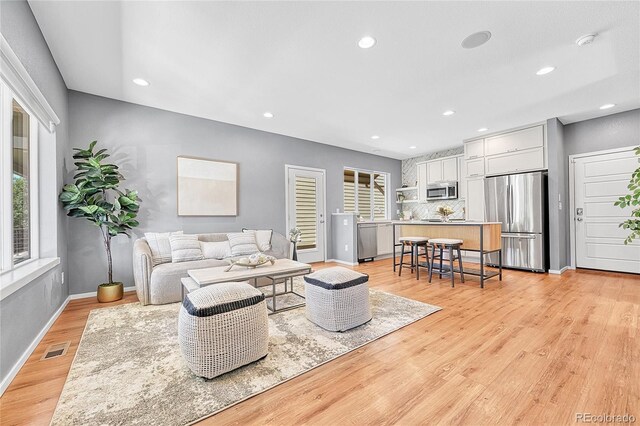 1903 W 66th Ave, Denver, CO 80221 - living area featuring light wood-style floors and recessed lighting