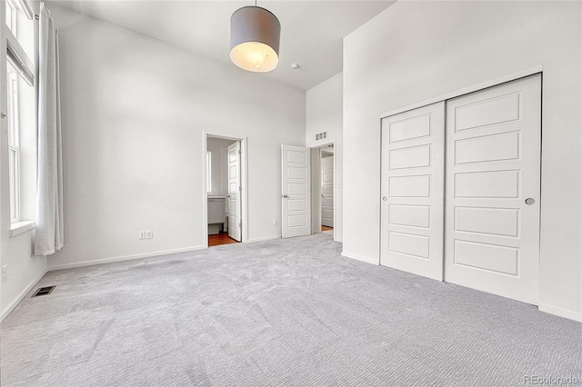 1903 W 66th Ave, Denver, CO 80221 - unfurnished bedroom with carpet floors, a towering ceiling, a closet, and connected bathroom