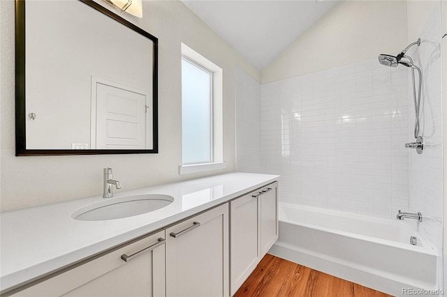 1903 W 66th Ave, Denver, CO 80221 - full bathroom with vanity, lofted ceiling, wood finished floors, and washtub / shower combination