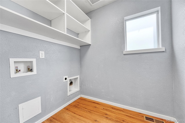 1903 W 66th Ave, Denver, CO 80221 - laundry area with hookup for an electric dryer, wood finished floors, and hookup for a washing machine